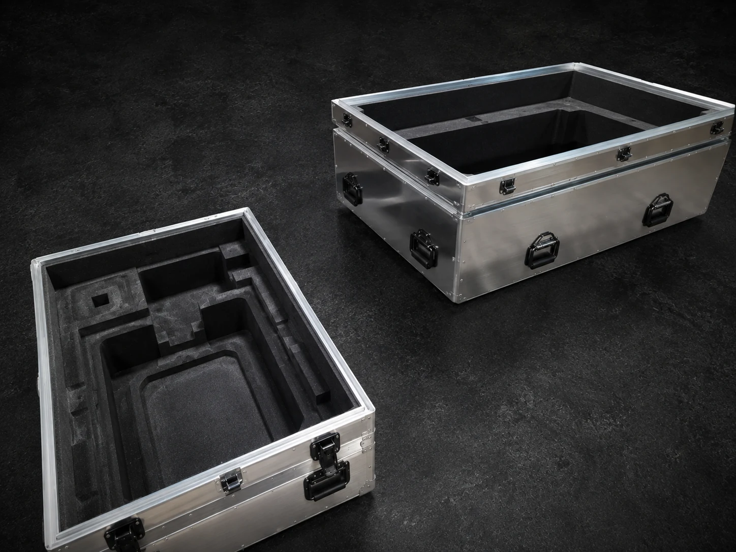Two open natural aluminum Impact cases, one fitted with custom routed foam