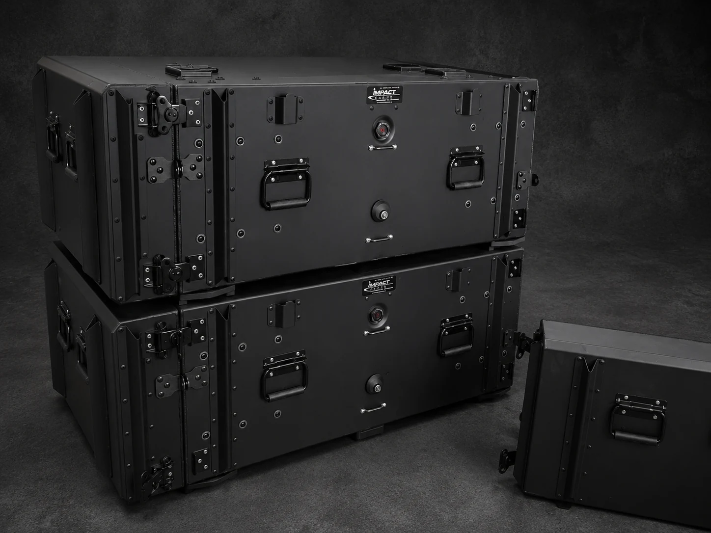 Two black Impact rackmount cases stacked, with a third lid set alongside