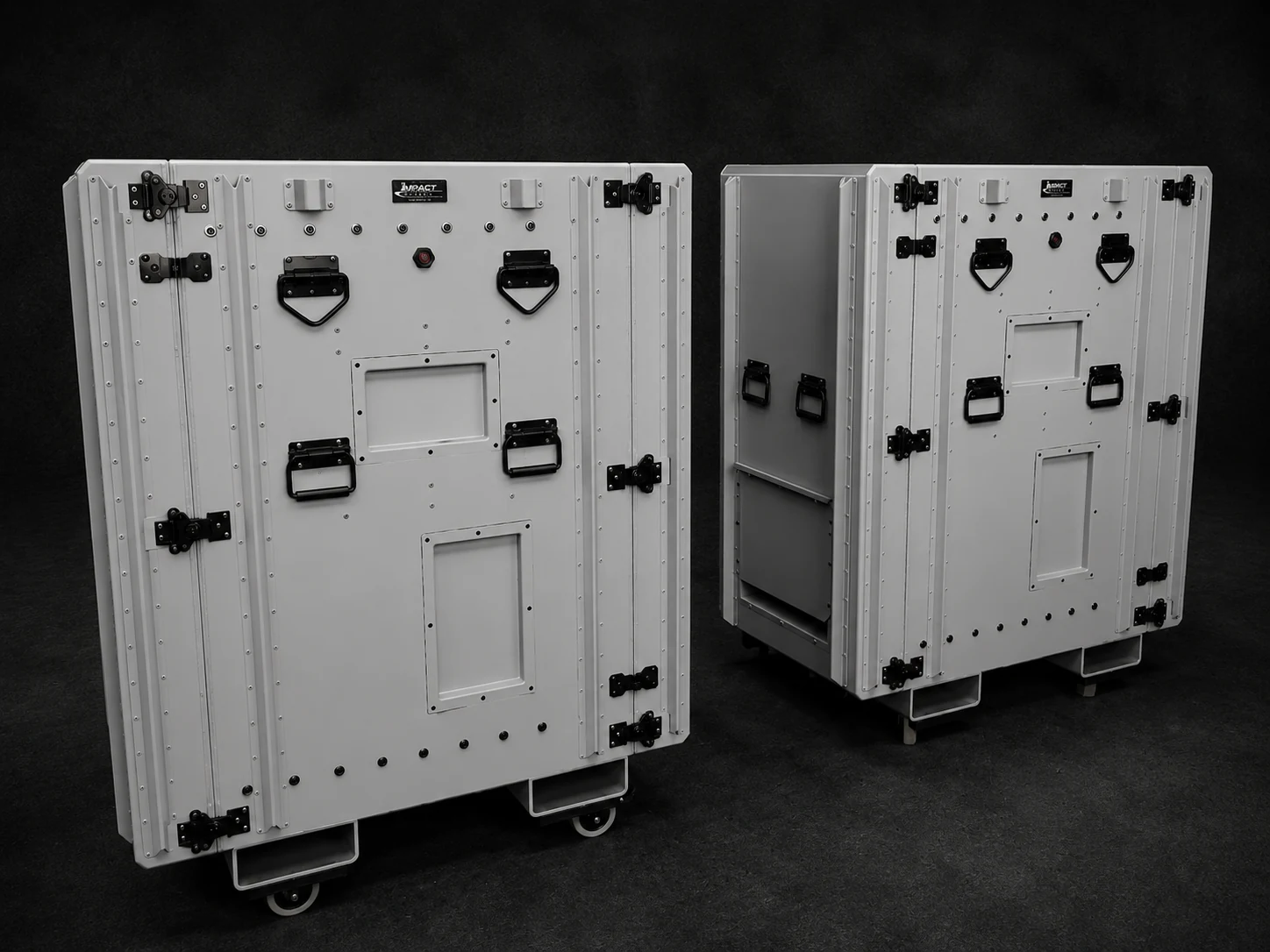 Pair of tall white Impact cases on caster bases with forklift pockets