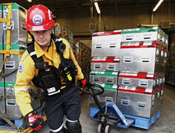 Responder moving a palletized stack of P.E.T.S. cases