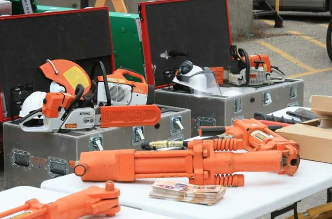 Hydraulic rescue tools and rotary saws staged on and around open P.E.T.S. cases